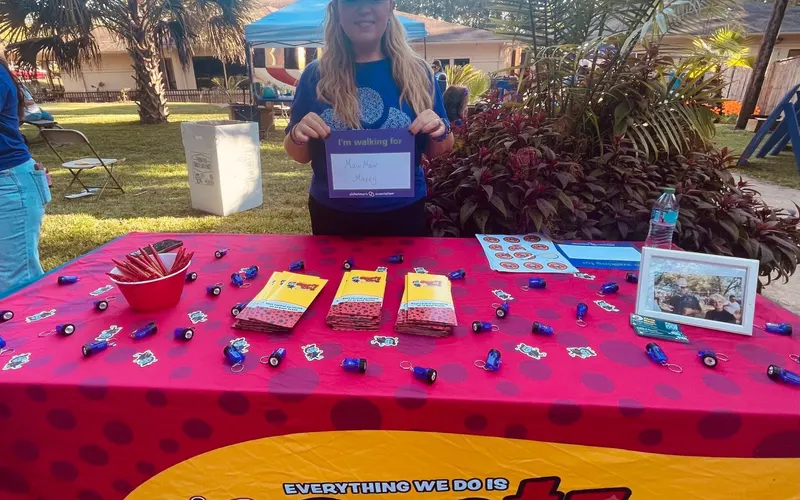 An East Texas family visiting the Spot On Pest Control table at a community event