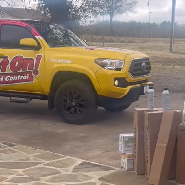A Spot On Pest Control team member in front of the ladybug-wrapped service truck in Lufkin, TX